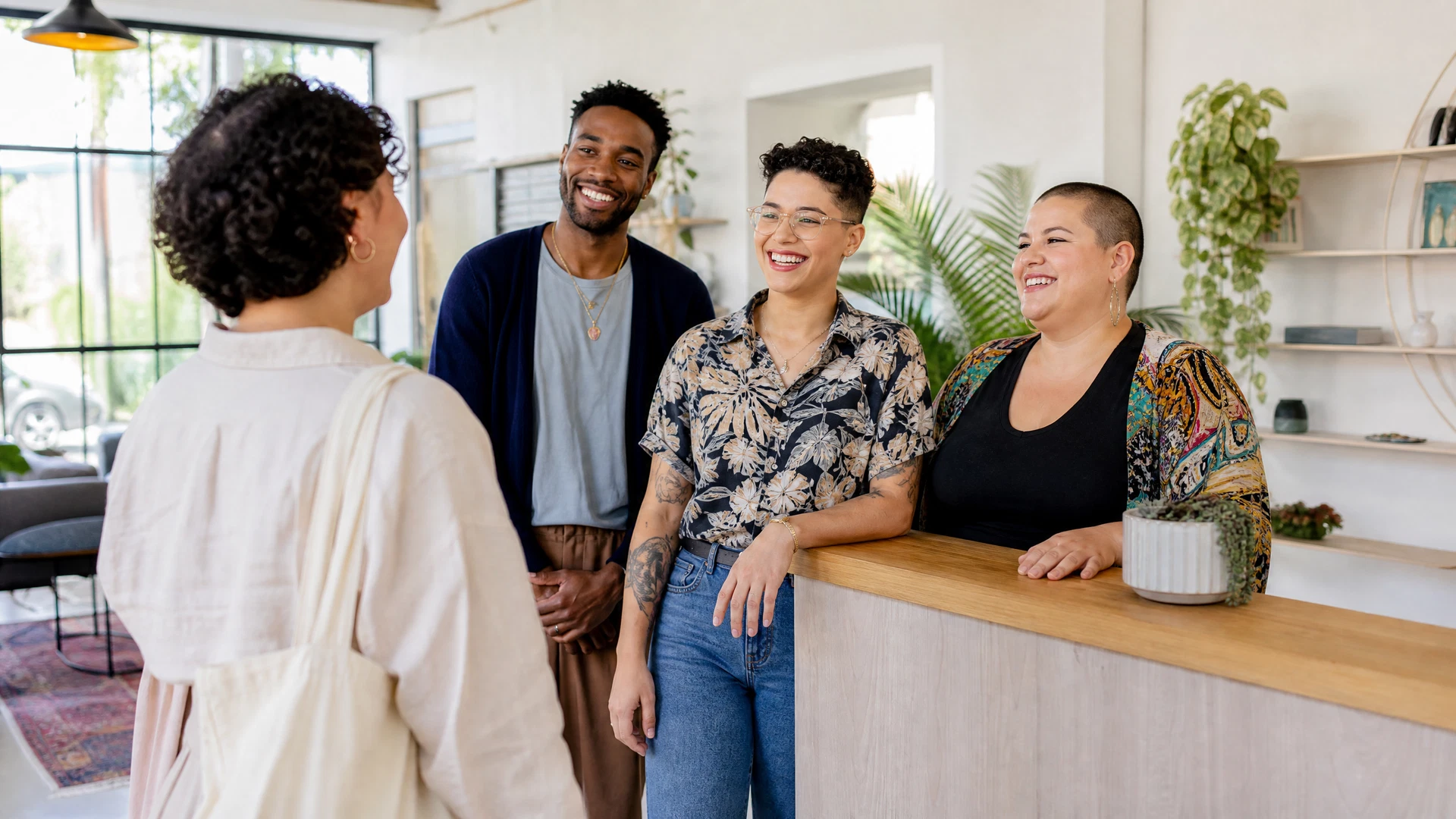 A local service team warmly welcoming a customer in a bright neighborhood business.